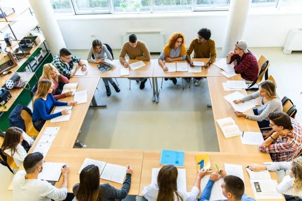A group of people sat around a desk